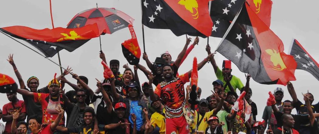 Supporters waving Papua New Guinea flags